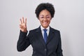 Beautiful african woman with curly hair wearing business jacket and glasses showing and pointing up with fingers number three Royalty Free Stock Photo