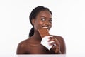 Beautiful african woman holding and eating a huge dark chocolate bar isolated on white background Royalty Free Stock Photo