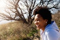 Beautiful african woman sitting outdoors and laughing Royalty Free Stock Photo