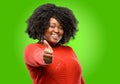 Beautiful african woman with curly hair isolated over green background Royalty Free Stock Photo
