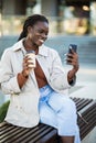 Beautiful African American woman taking selfie on mobile phone camera, showing victory sign. Emotional blogger streaming video Royalty Free Stock Photo