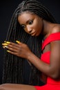 Beautiful african woman touching long braided hair. Royalty Free Stock Photo