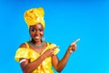 beautiful african woman in yellow silk turban on head and dress with silver neckless and earrings , nose piercing in Royalty Free Stock Photo