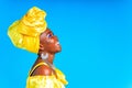 beautiful african woman in yellow silk turban on head and dress with silver neckless and earrings , nose piercing in Royalty Free Stock Photo