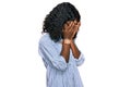 Beautiful african young woman wearing casual clothes and glasses with sad expression covering face with hands while crying Royalty Free Stock Photo