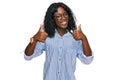 Beautiful african young woman wearing casual clothes and glasses success sign doing positive gesture with hand, thumbs up smiling Royalty Free Stock Photo