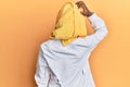 Beautiful african young woman wearing doctor uniform and hijab backwards thinking about doubt with hand on head Royalty Free Stock Photo