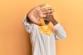 Beautiful african young woman wearing traditional islamic hijab scarf covering eyes with hands and doing stop gesture with sad and Royalty Free Stock Photo