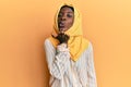 Beautiful african young woman wearing traditional islamic hijab scarf looking at the camera blowing a kiss with hand on air being Royalty Free Stock Photo
