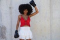 Beautiful Afro-American woman with boxing gloves claiming women`s rights against mistreatment and breast cancer. Concept of women