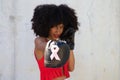 Beautiful Afro-American woman with boxing gloves claiming women`s rights against mistreatment and breast cancer. Concept of women