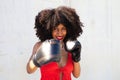 Beautiful Afro-American woman with boxing gloves claiming women`s rights against mistreatment and breast cancer. Concept of women