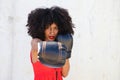 Beautiful Afro-American woman with boxing gloves claiming women`s rights against mistreatment and breast cancer. Concept of women