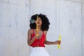 Beautiful afro american woman making soap bubbles in the park. The woman is having a great time with the bubbles and that`s why Royalty Free Stock Photo