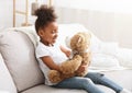 Beautiful afro girl holding big toy teddy bear Royalty Free Stock Photo