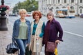 Beautiful aged women walk together in city at daytime Royalty Free Stock Photo