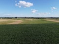 Beautiful agricultural landscape, open field with blue sky and white clouds. Farmfields from a bird`s eye view Royalty Free Stock Photo