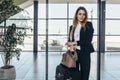 Beautiful airhostess standing in her uniform with her bags ready for a flight Royalty Free Stock Photo