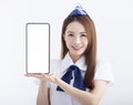 Beautiful Airline stewardess showing the mobile phone with blank screen on white background