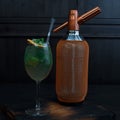 Beautiful alcoholic cocktail in an elegant glass with the addition of tequila and fresh mint leaves stands on a vintage table