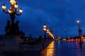 Beautiful Alexandre III bridge over the Seine river at rainy night , Paris. France Royalty Free Stock Photo