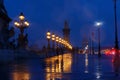 Beautiful Alexandre III bridge over the Seine river at rainy night , Paris. France Royalty Free Stock Photo