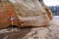 Beautiful in all weathers, colorful sandstone cliffs with fishing flags. Beautiful coast of the Baltic Sea with caves