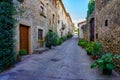 Beautiful alley with old stone houses and pots on the street with plants and flowers, Monells, Girona, Catalonia. Royalty Free Stock Photo