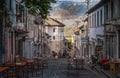 Beautiful alley in old town Gjirokaster on the background of the mountains, Albania