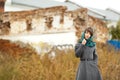 Beautiful alone woman in grey coat outdoors