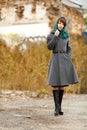 Beautiful alone woman in grey coat outdoors