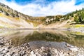 Beautiful alpine lake with calm water and reflection of the mountain peak in Wyoming Royalty Free Stock Photo