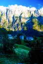 Beautiful alpine mountain landscape on summer day with little village in the valley Royalty Free Stock Photo