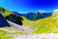 Beautiful alps landscape. Beautiful majestic mountain peaks with paths and cars of tourists.