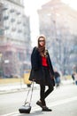 Beautiful amazing brunette woman with long wavy hairstyle in spring or fall stylish urban outfit walking on the street. Street fas Royalty Free Stock Photo