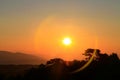 Beautiful amazing sunrise over the mountain with halo lens flare