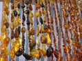 Beautiful amber beads of different colors with a blurred background