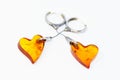 Amber heart earrings on a silver chain. On a white background. Royalty Free Stock Photo