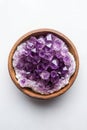 Beautiful amethyst crystals in a wooden bowl, white isolate background Royalty Free Stock Photo