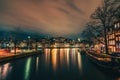 Beautiful Amsterdam city at evening time, Netherlands. Night illumination reflected in Amstel river Royalty Free Stock Photo