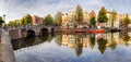 Beautiful Amsterdam sunset. Typical old dutch houses on the bridge and canals in spring, Netherlands Royalty Free Stock Photo