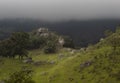 Beautiful ancient Monoliths at the top of little hill with big cloudy mountains