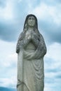 Beautiful ancient stone statue of Virgin Mary praying Royalty Free Stock Photo