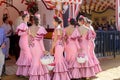 Beautiful andalusian young women dressed in traditional costumes at the Seville`s April Fair. Royalty Free Stock Photo