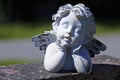 Beautiful angel closing his eyes on a tombstone Royalty Free Stock Photo