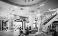 A beautiful angel decoration on a fountain and people sitting at Terminal 21 Shopping Mall Asoke junction Sukhumvit road Bangkok