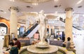  A beautiful angel decoration on a fountain and people sitting at Terminal 21 Shopping Mall Asoke junction Sukhumvit road Bangkok 