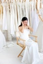 Beautiful angry and agressive shouting bride wearing white dress, screaming and crying at someone