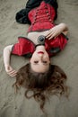 Beautiful anime woman in the sand. Red corset on the girl`s body. Bright red makeup on the face Royalty Free Stock Photo