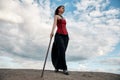 Beautiful anime woman in the sand. Red corset on the girl`s body. Bright red makeup on the face Royalty Free Stock Photo